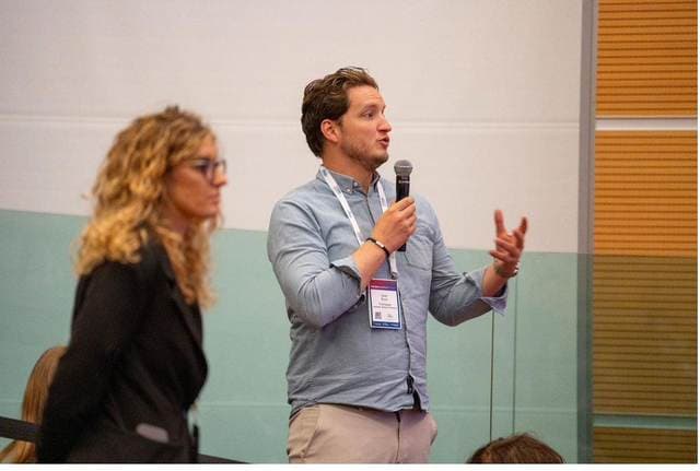 A delegate speaking from the floor at the Rimini Summit
